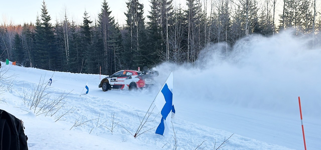 A rally car drifting in snow